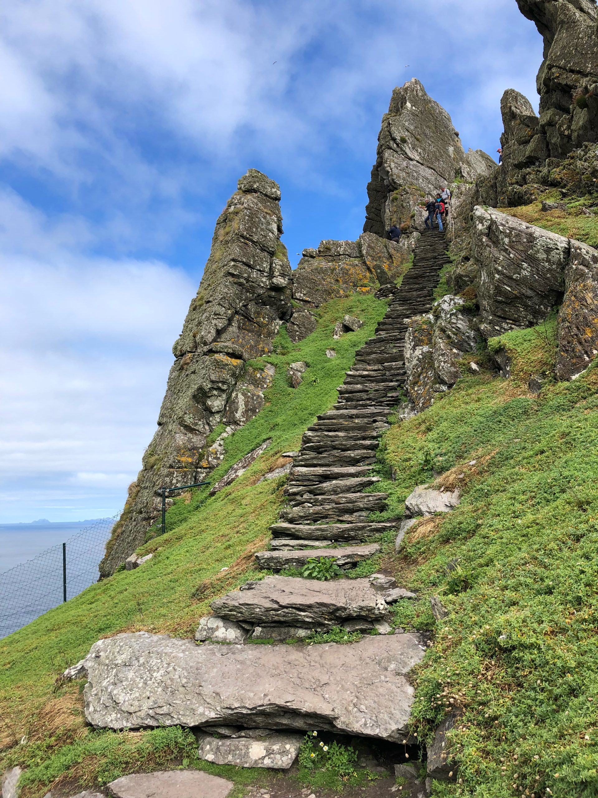 Stone steps leading up Skellig Michael, Ireland. Rugged landscape and blue sky.