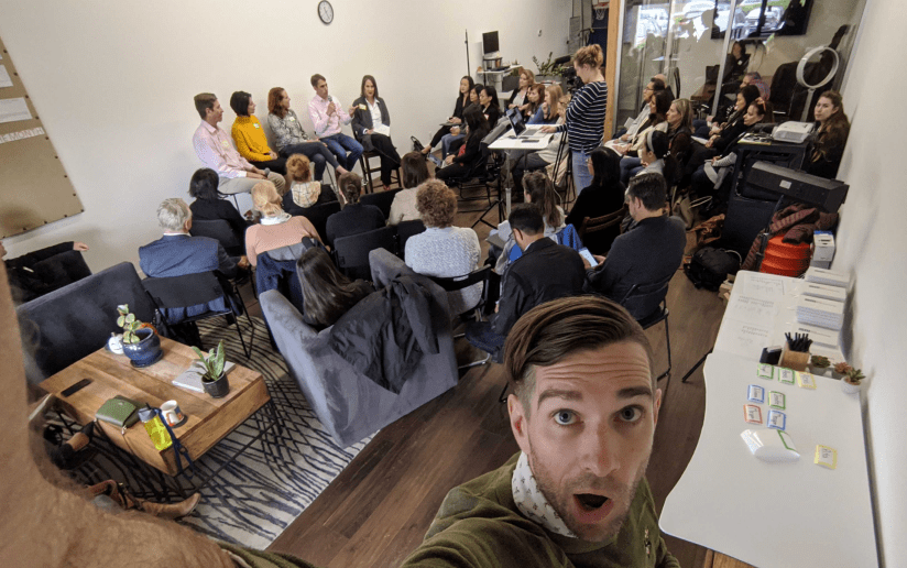 Consultant taking a selfie at a marketing workshop with attendees.