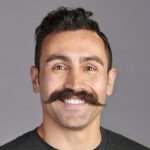 Smiling man with a large, impressive mustache