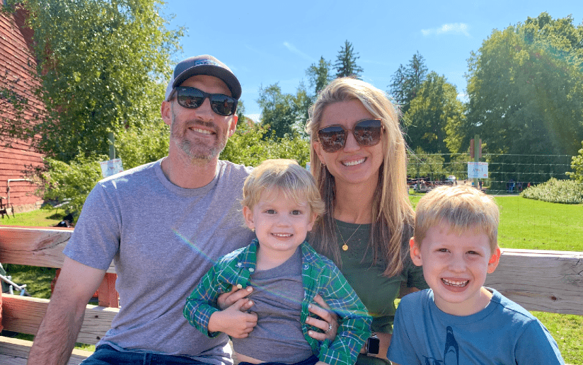 Corinne Littleton with her family outdoors, smiling for the camera.