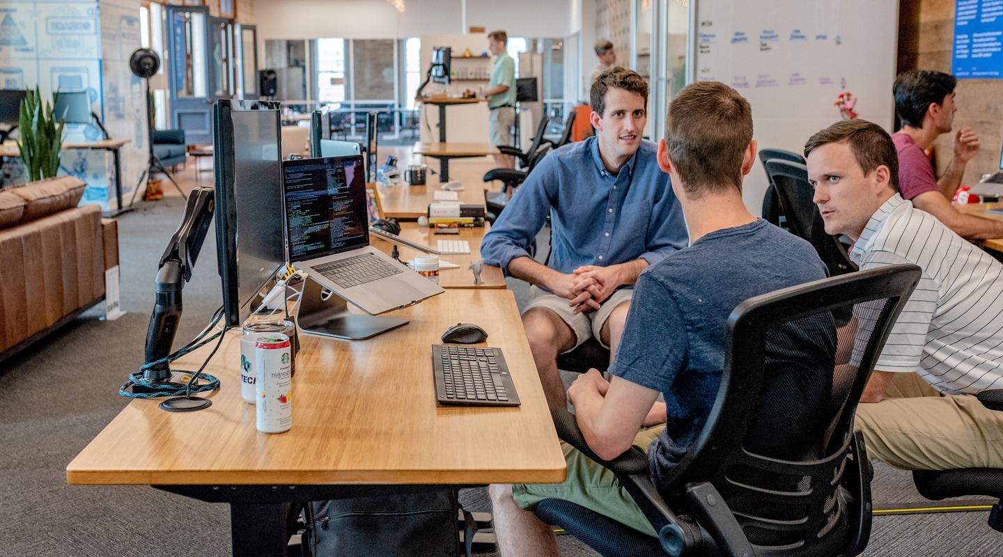 Team of consultants discussing a project in modern office setting.