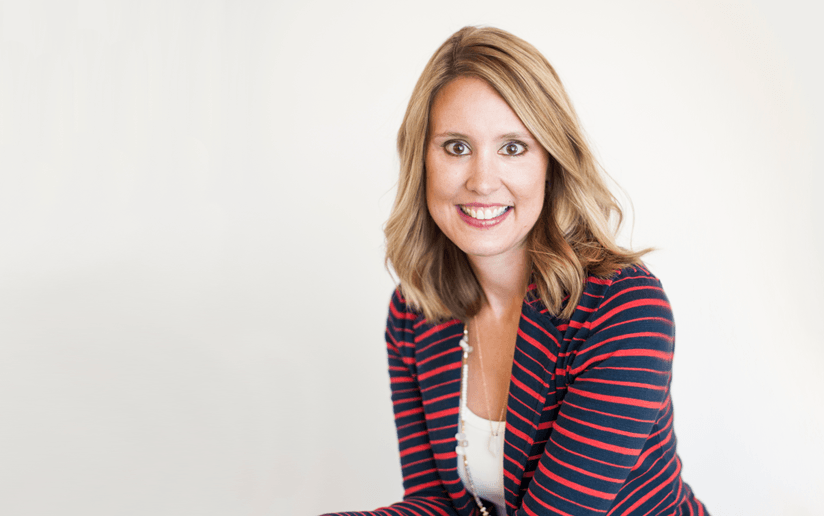 Smiling woman in a red and black striped blazer