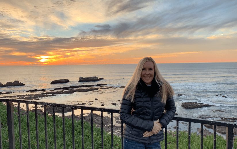 Laura Wilton at sunset on the coast, flexing a marketing lifestyle.