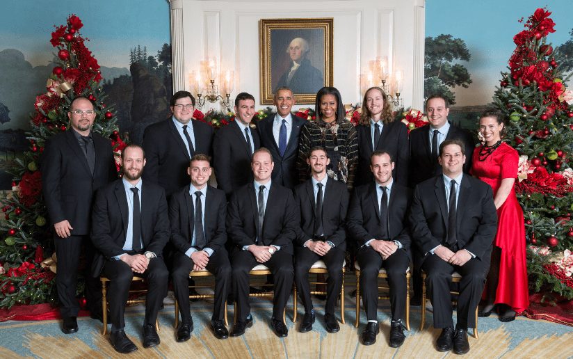 President Obama, Michelle Obama, and Straight No Chaser pose for a photo at the White House.