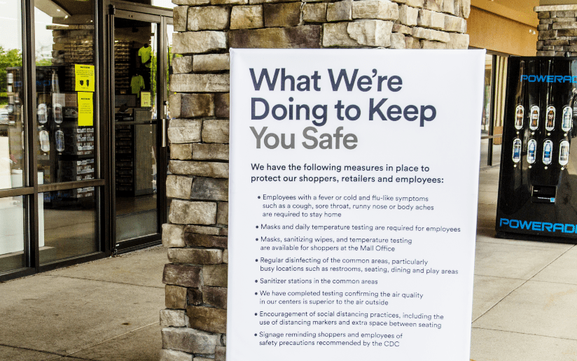 Sign at a shopping center listing COVID-19 safety measures for shoppers and employees. "What We're Doing to Keep You Safe.