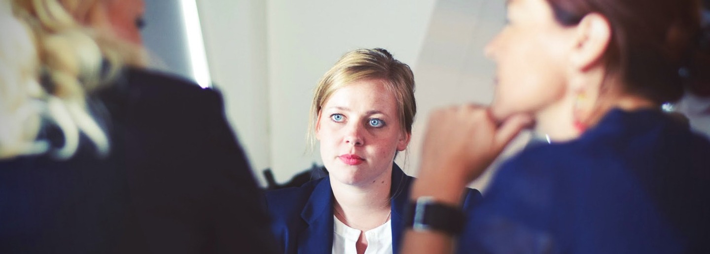 Woman in a business meeting, focusing on building client relationships.