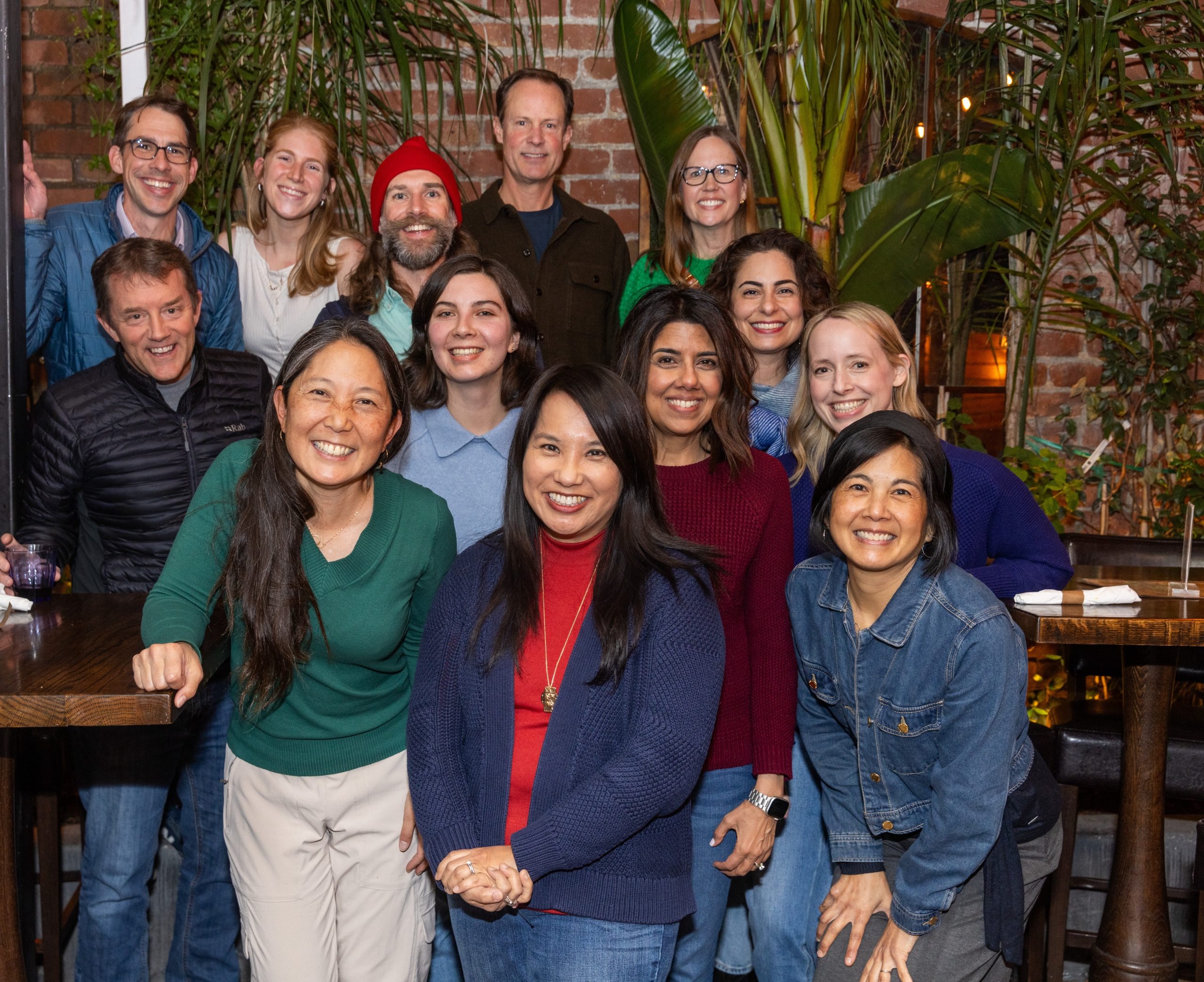 The EM Marketing team, a diverse group of men and women smiling while posing for a picture at an indoor event.