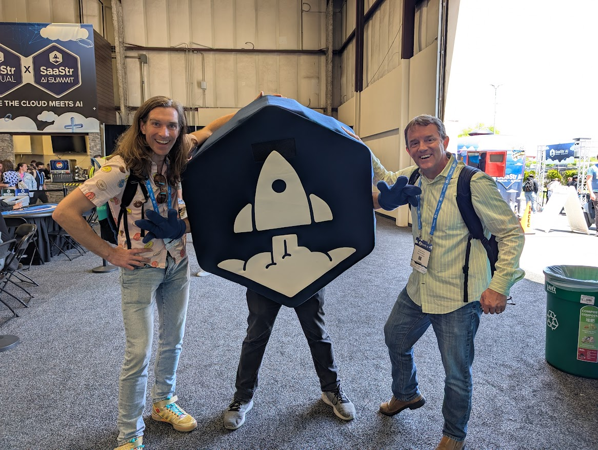 Two men and a person with a SaaStr logo at the SaaStr Annual Summit.